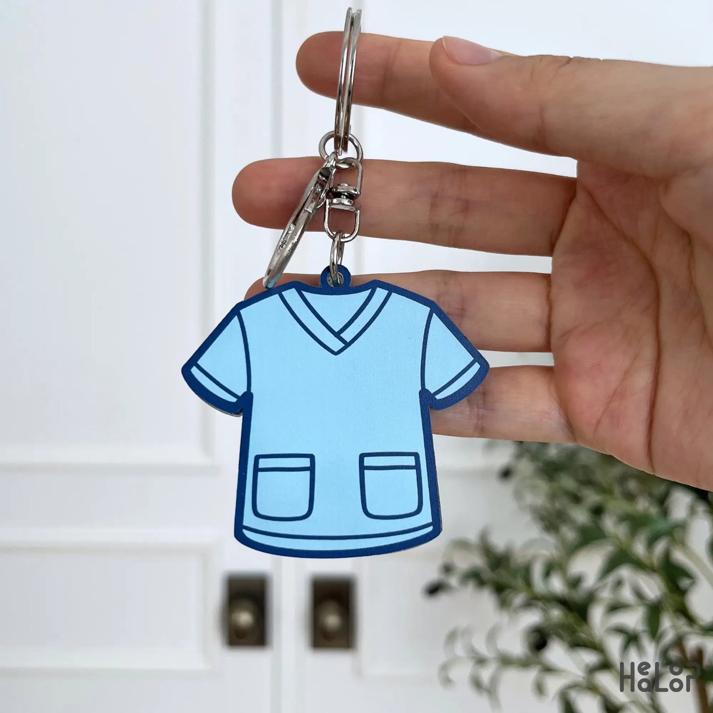Back view of blue scrub top custom nurse shaker keychain with silver key ring and lobster clasp.