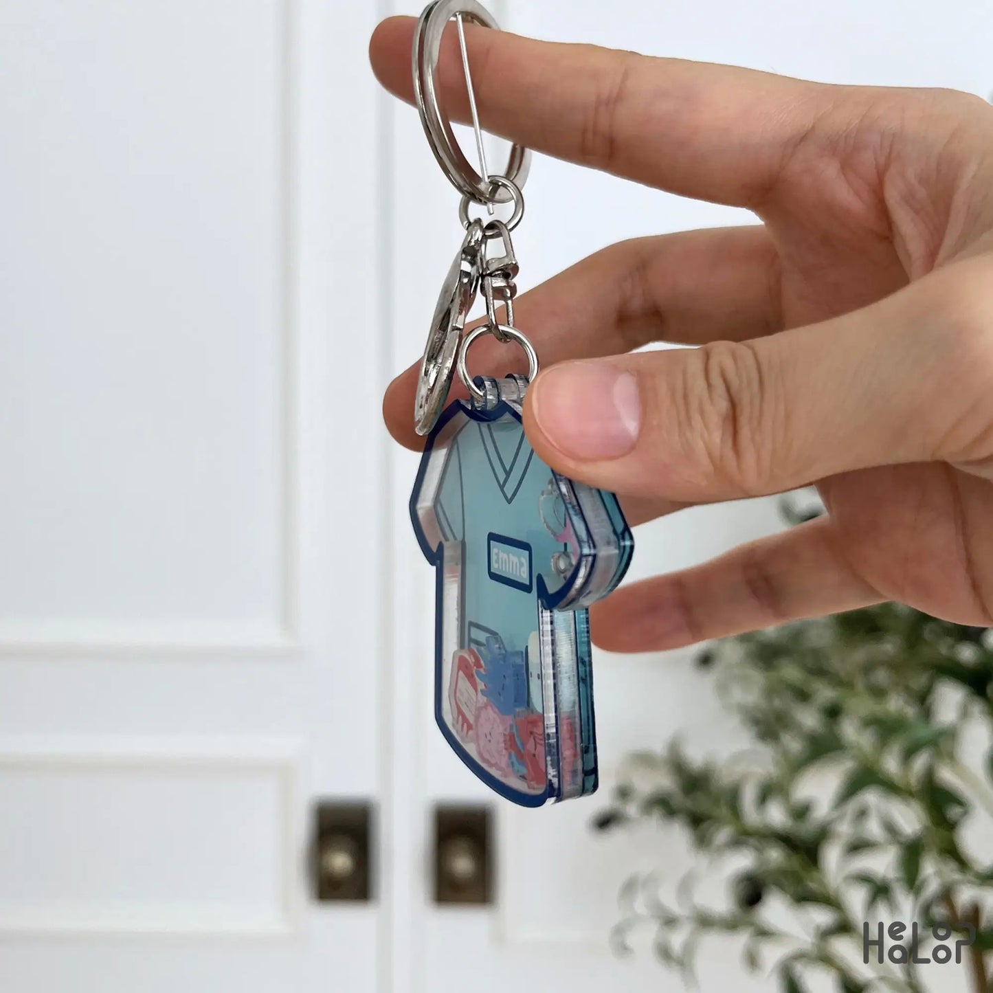 Side view showing the layered acrylic construction of a custom nurse shaker keychain with moving charms.