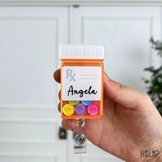 Front close-up of a personalized pharmacist prescription bottle shaker badge reel with colorful pill charms.