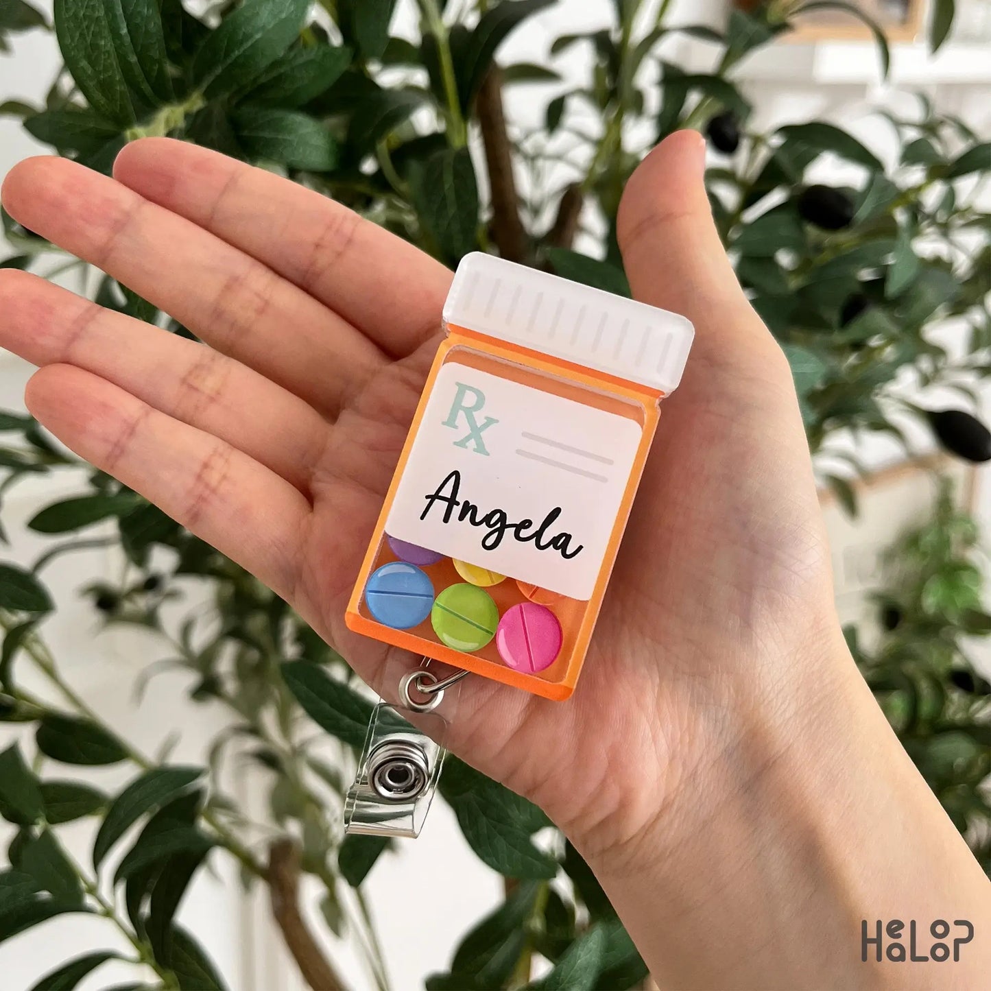 Custom pharmacist prescription bottle shaker badge reel personalized with a name and colorful movable pill charms.