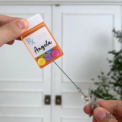 Custom pharmacist prescription bottle shaker badge reel with retractable badge cord and personalized name.