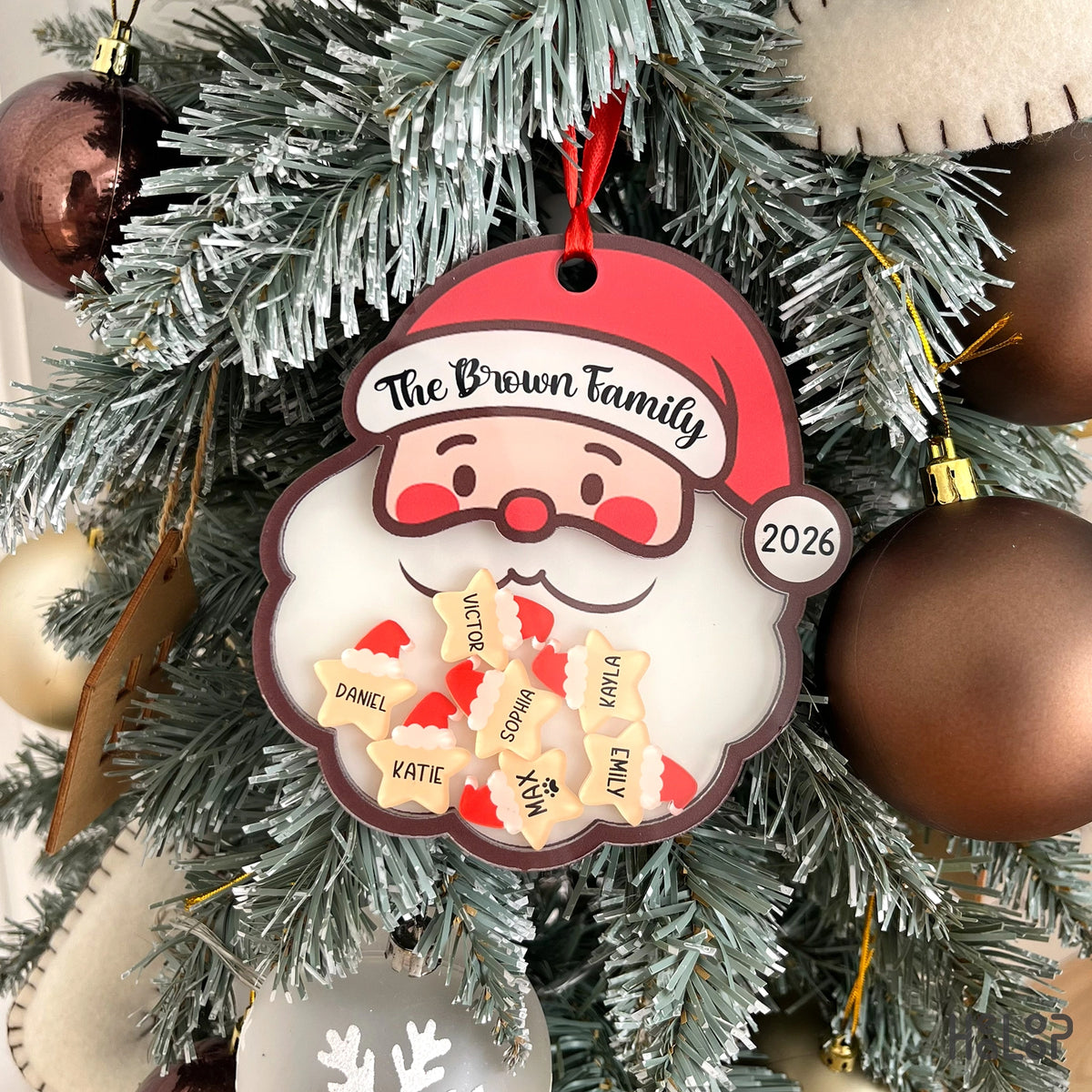 Custom Santa family shaker ornament with personalized family name, year, and individual name charms displayed on a Christmas tree.