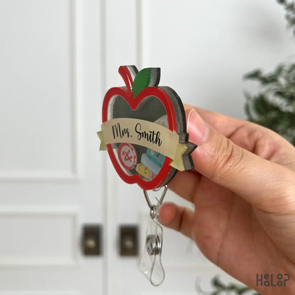 Side profile of custom teacher apple shaker badge reel showing layered acrylic construction