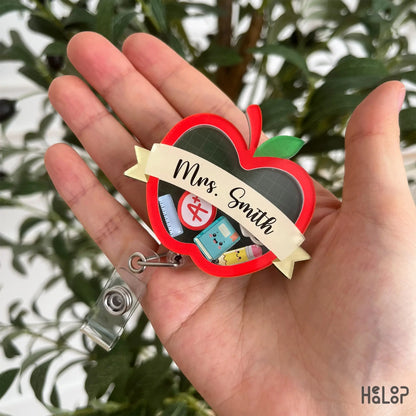 Personalized teacher apple shaker badge reel featuring custom name and classroom charms