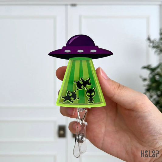 Close-up of the Cute Alien UFO Shaker Badge Reel with playful UFO design and movable alien shaker charms.