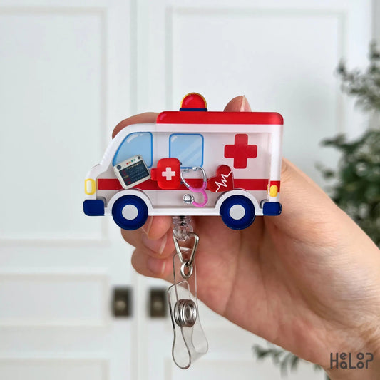 Front view of a cute ambulance shaker badge reel with movable medical charms for EMTs, EMS professionals, paramedics, and emergency medicine teams.