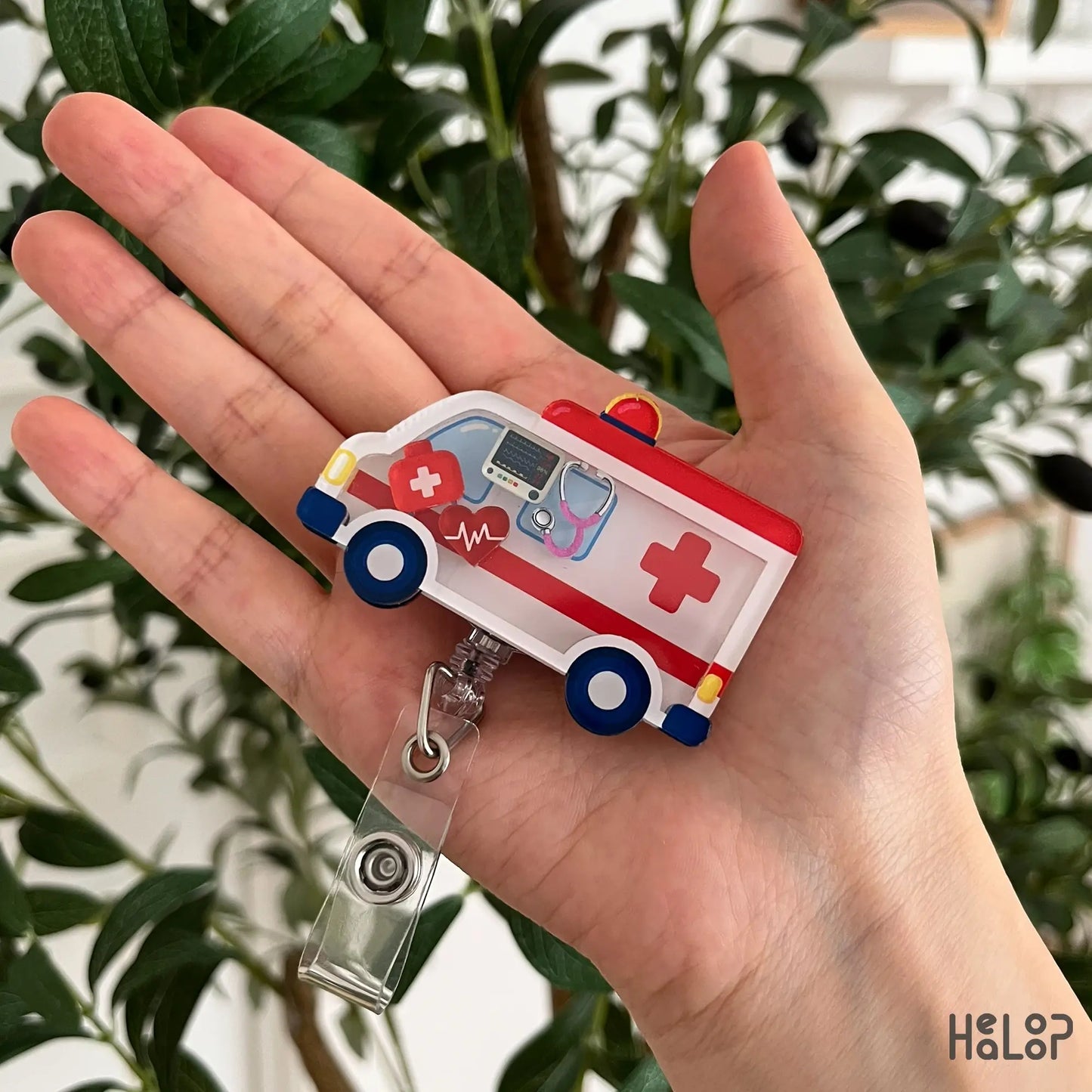 Cute ambulance shaker badge reel featuring movable medical charms, perfect for EMTs, paramedics, EMS professionals, ER staff, and healthcare workers.