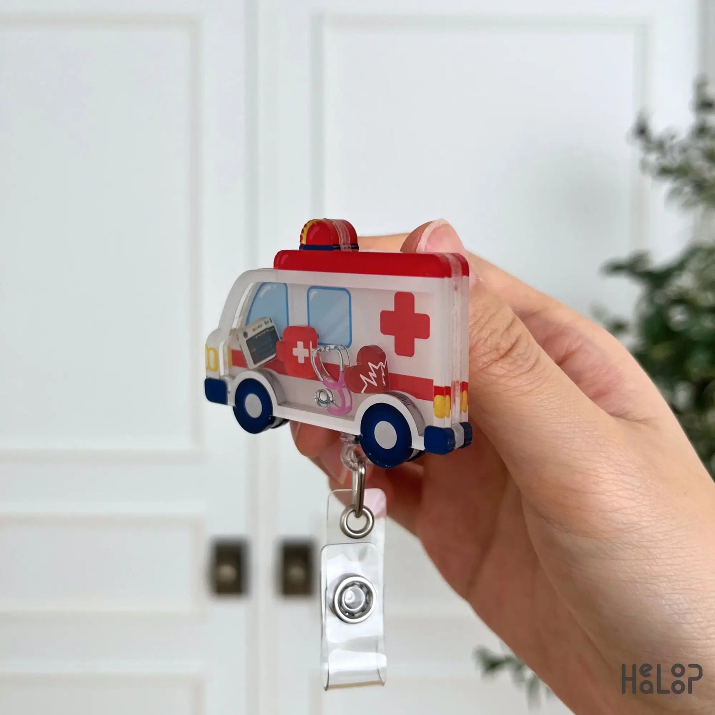 Side profile of a layered acrylic ambulance shaker badge reel showing its premium three-layer construction.
