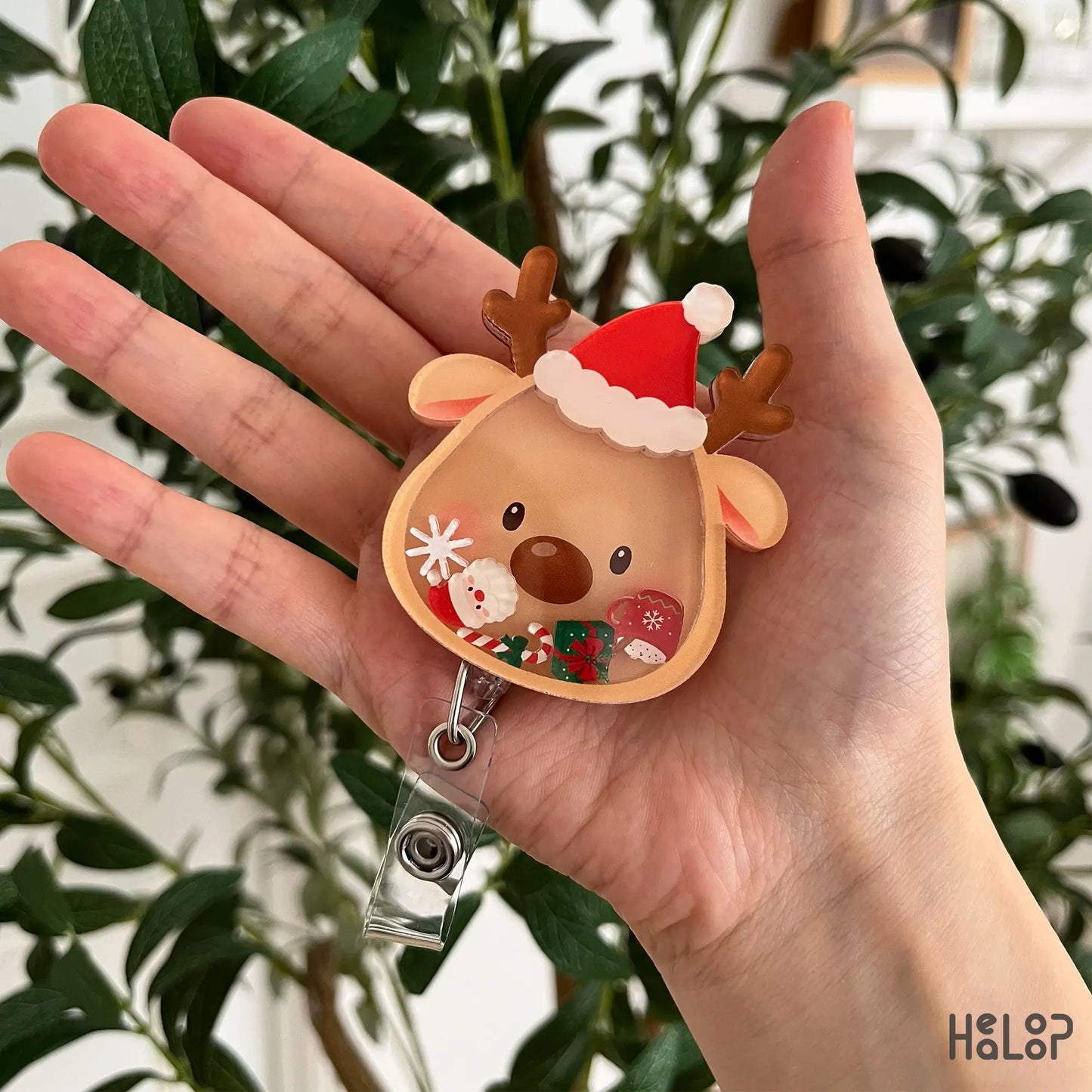 Cute Christmas Reindeer Shaker Badge Reel featuring a Santa hat and festive movable shaker charms for nurses, healthcare workers, and holiday lovers.