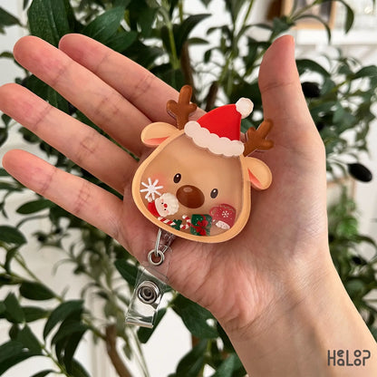 Cute Christmas Reindeer Shaker Badge Reel featuring a Santa hat and festive movable shaker charms for nurses, healthcare workers, and holiday lovers.