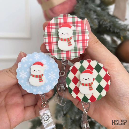 Cute Christmas Snowman Badge Reel collection showing three festive background designs for holiday ID badges