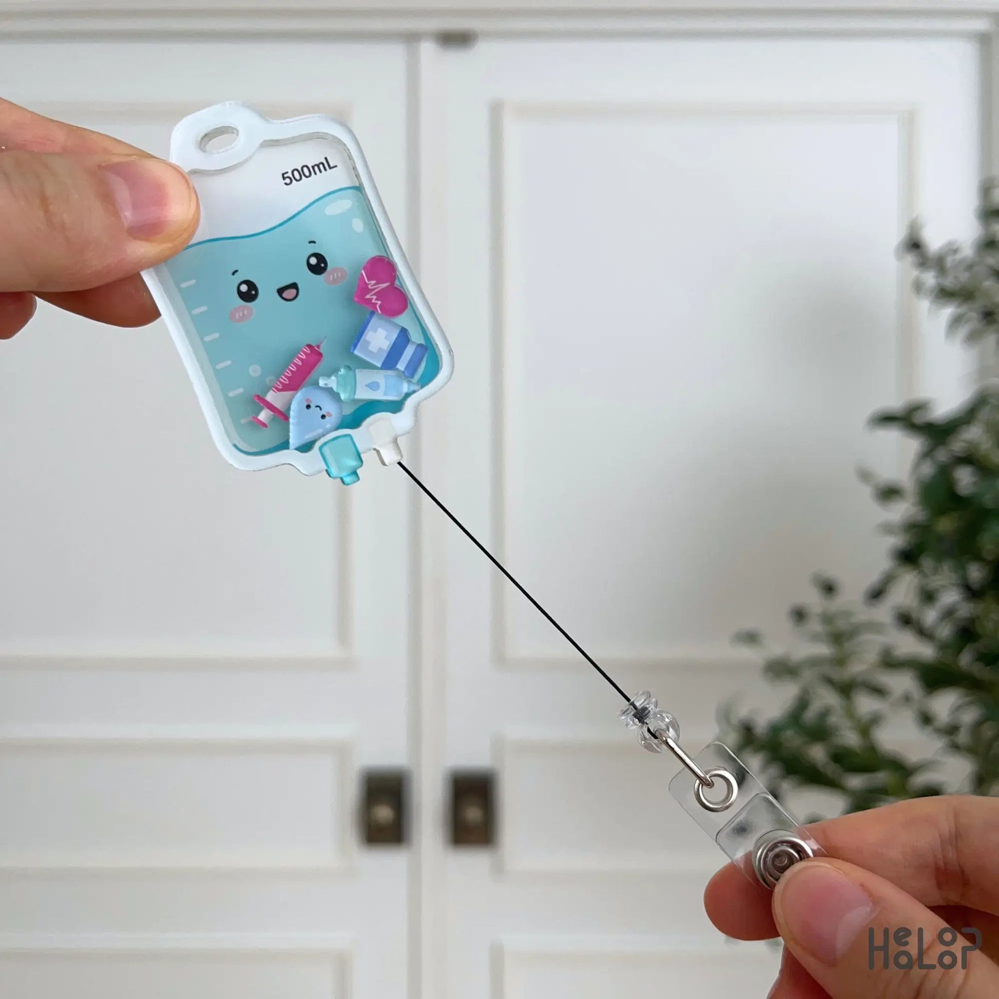 Retractable Cute IV Bag Shaker Badge Reel featuring interactive acrylic IV fluid bag design with adorable medical-themed shaker charms.