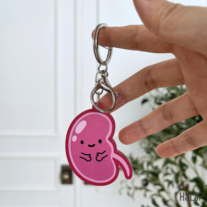 Back view of the cute pink kidney anatomy keychain with a smiling character design.