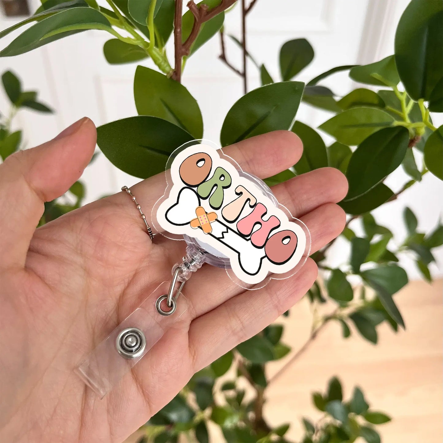 Cute orthopedic badge reel with colorful ORTHO lettering – great gift for nurses and healthcare workers