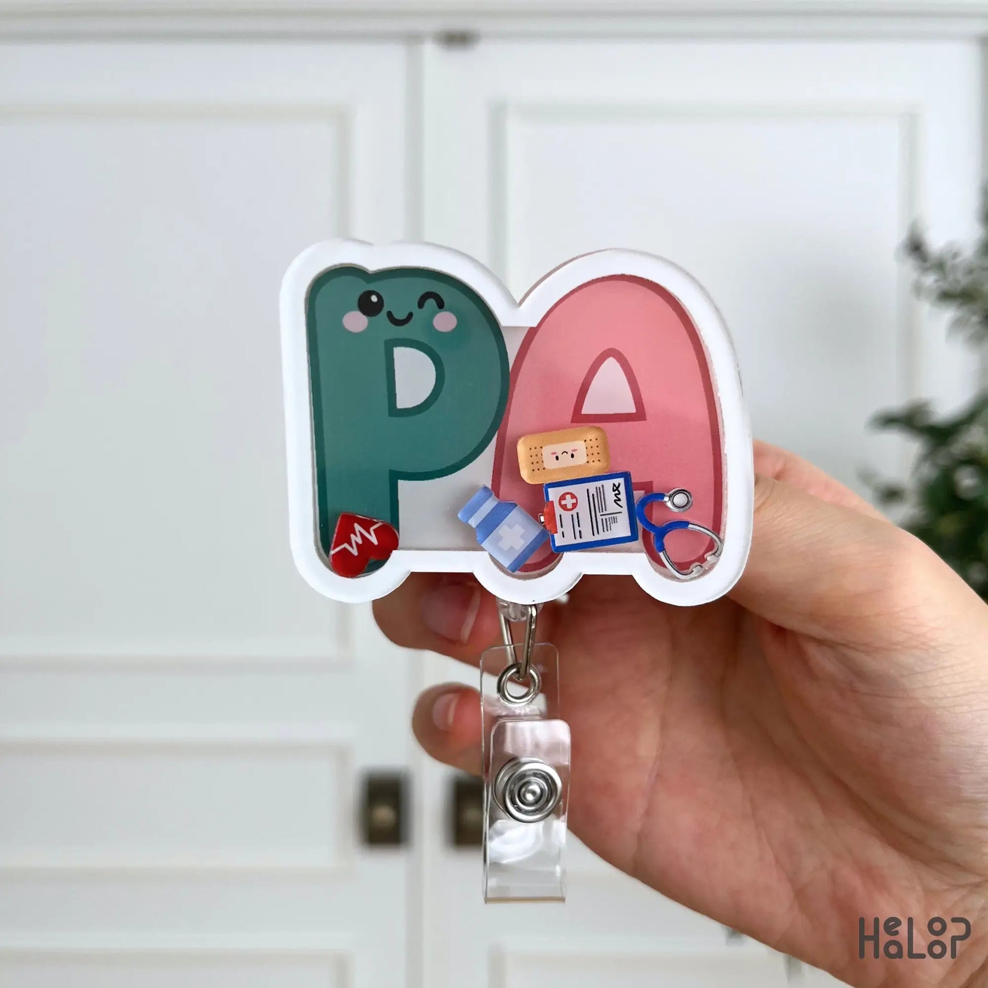 Close-up of the Cute PA Shaker Badge Reel featuring colorful medical charms and a fun Physician Assistant badge holder design.