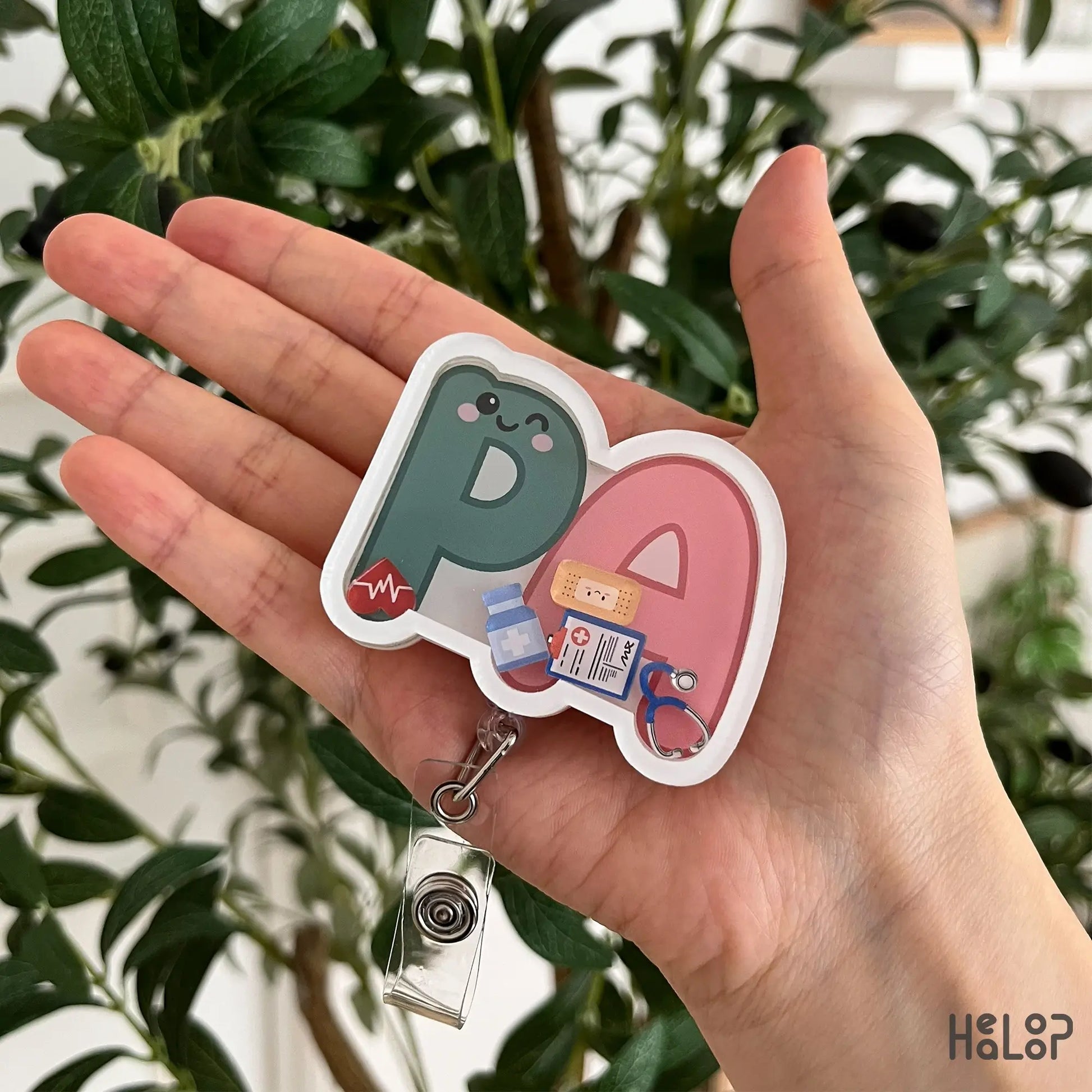 Cute PA Shaker Badge Reel featuring Physician Assistant letters and movable medical charms, retractable badge holder for healthcare professionals.