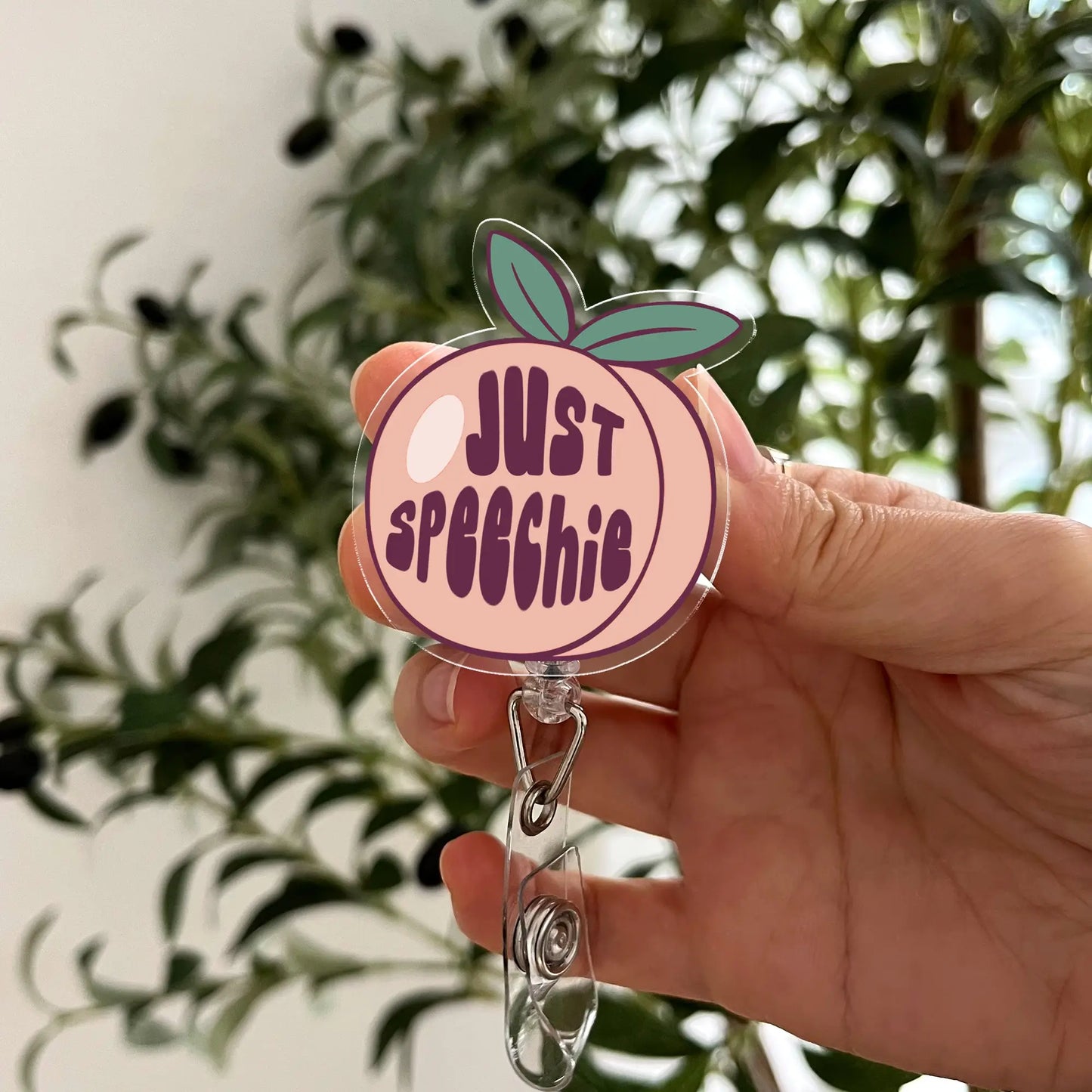 Cute peach badge reel with Just Speechie quote – ideal for SLPs, nurses, or teachers