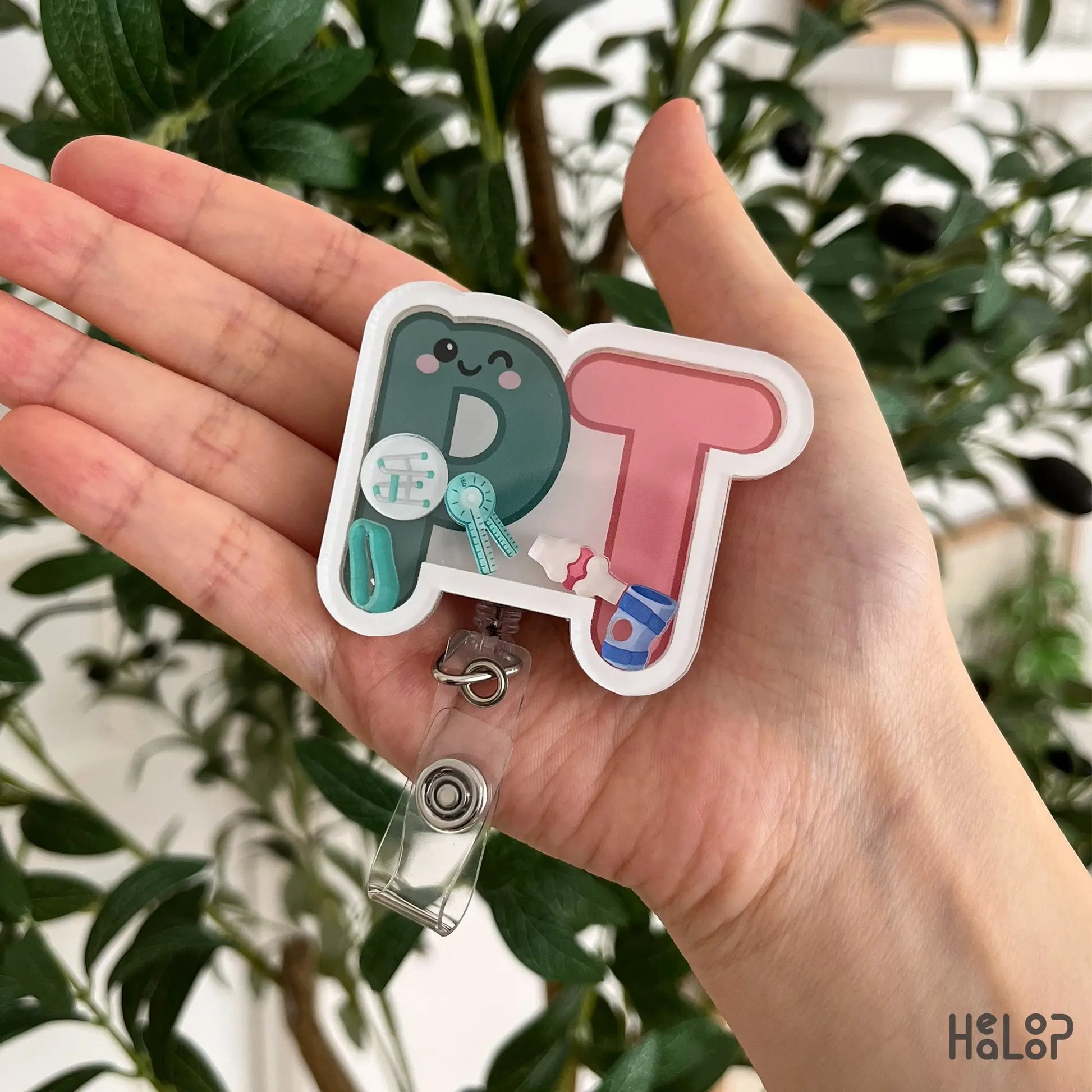 Cute PT Shaker Badge Reel close-up featuring physical therapy themed shaker charms for physical therapists, PTA students, and rehabilitation professionals.