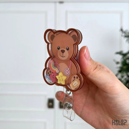 Side profile of the Cute Teddy Bear Shaker Badge Reel showing premium layered acrylic construction and movable charms.
