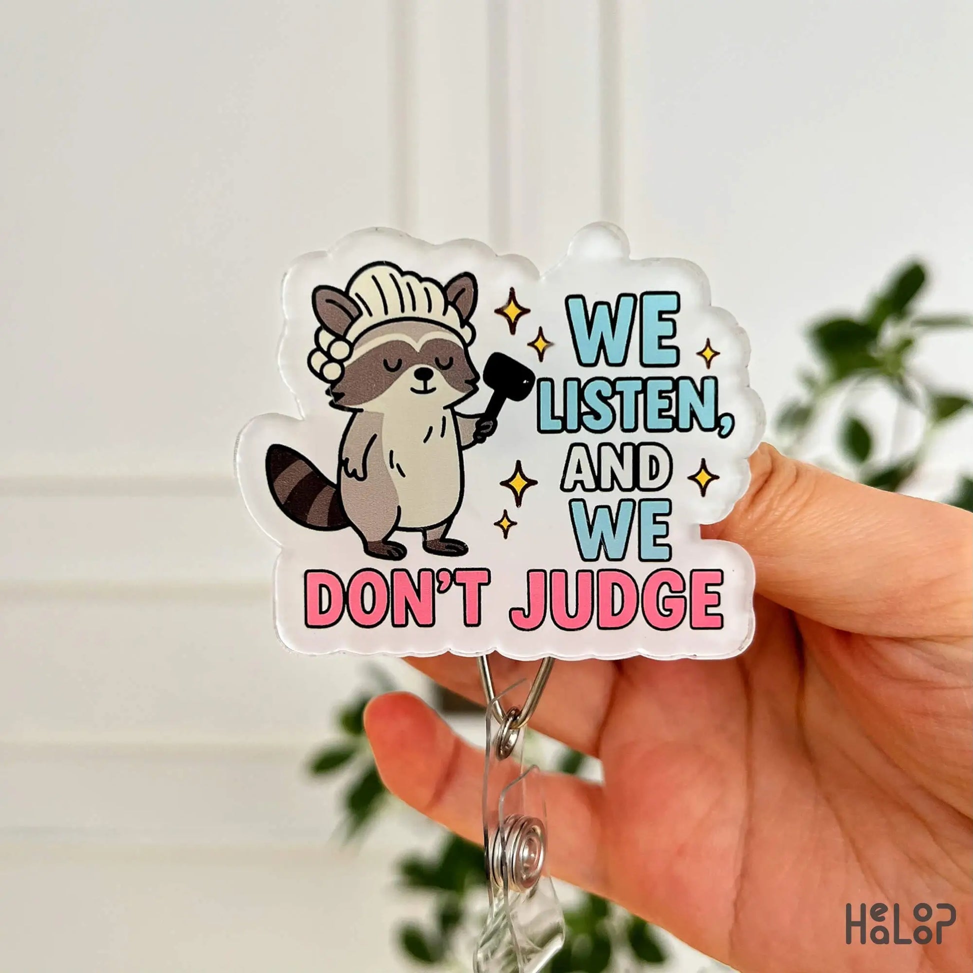 Front close-up of “We Listen and We Don’t Judge” badge reel – funny retractable ID holder by Healoop