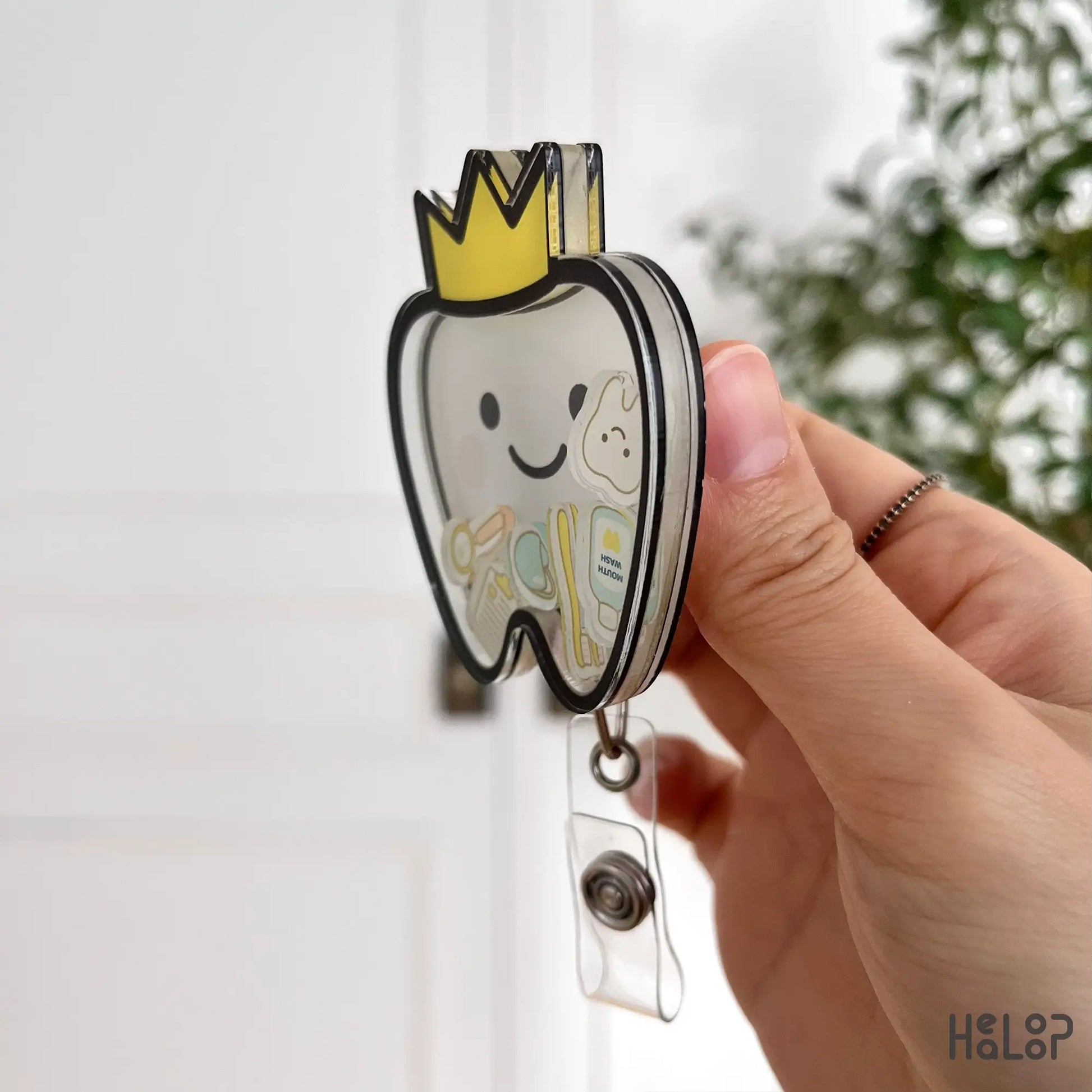 Dental shaker badge reel side angle — layered acrylic design with retractable clip