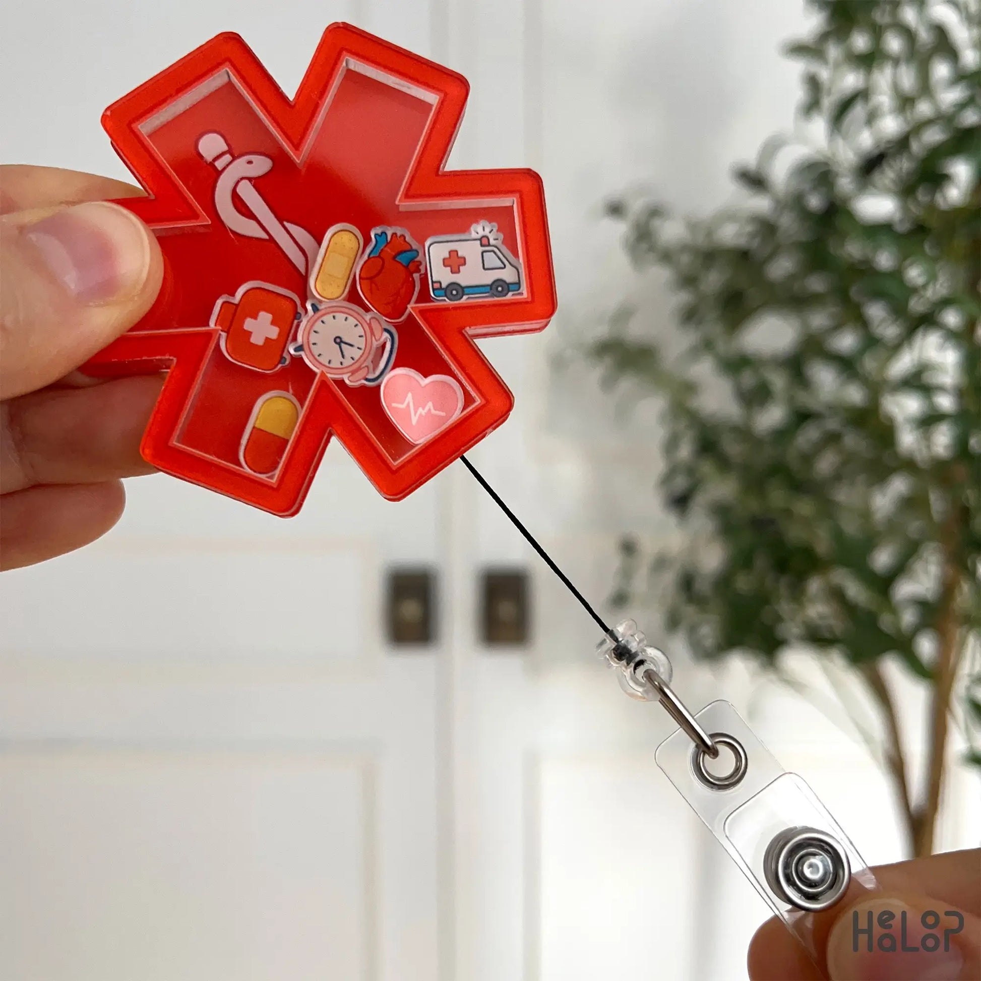 EMS badge reel extended with black retractable cord and ID clip