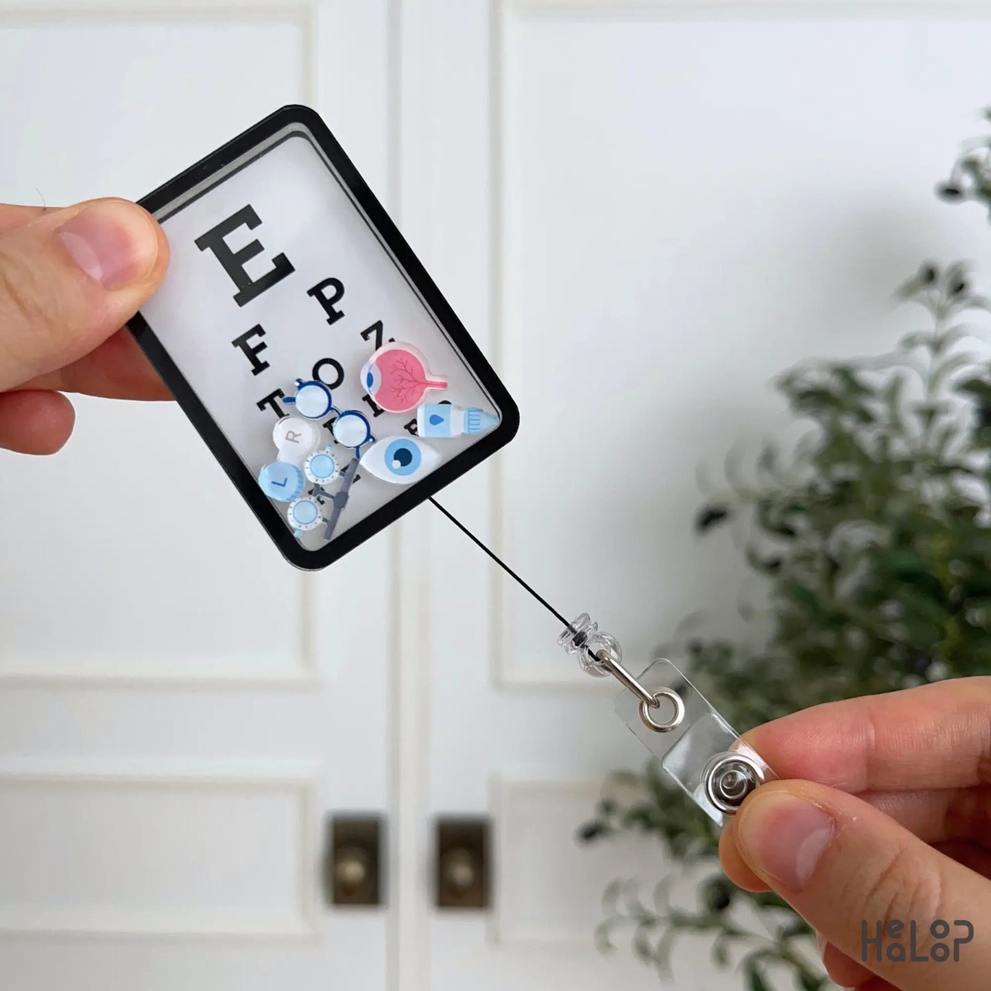 Retractable Eye Chart Shaker Badge Reel with colorful eye care charms for optometrists and ophthalmologists.