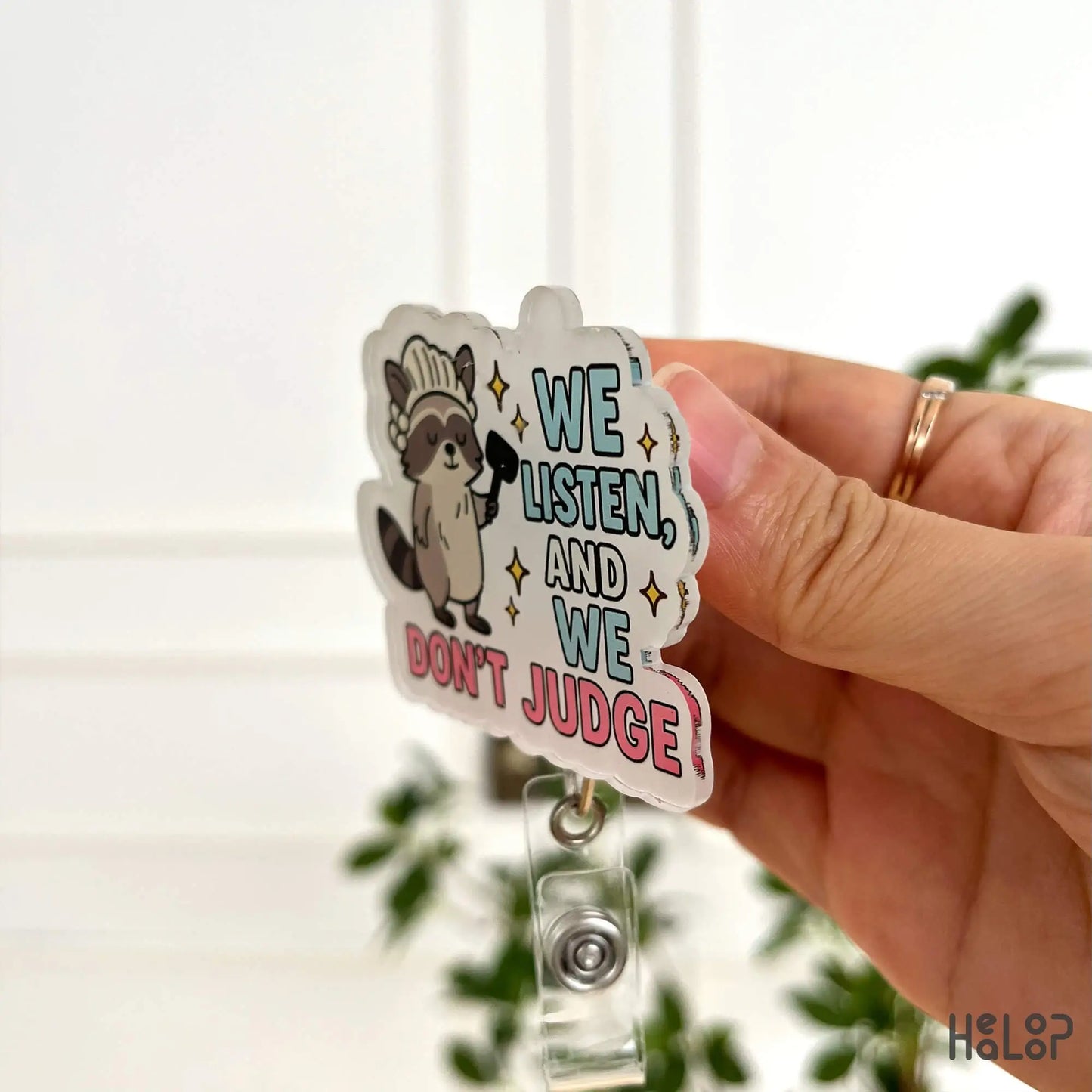 Side view of funny raccoon badge reel saying “We Listen and We Don’t Judge” – durable retractable ID clip