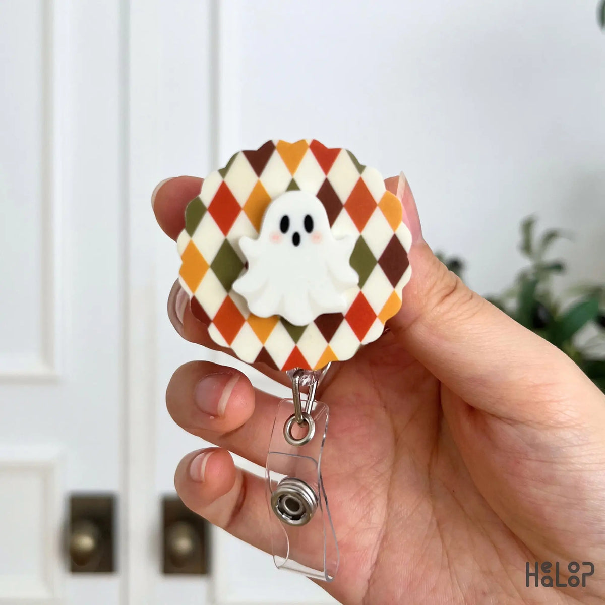 Ghost Badge Reel with orange, brown and olive argyle pattern