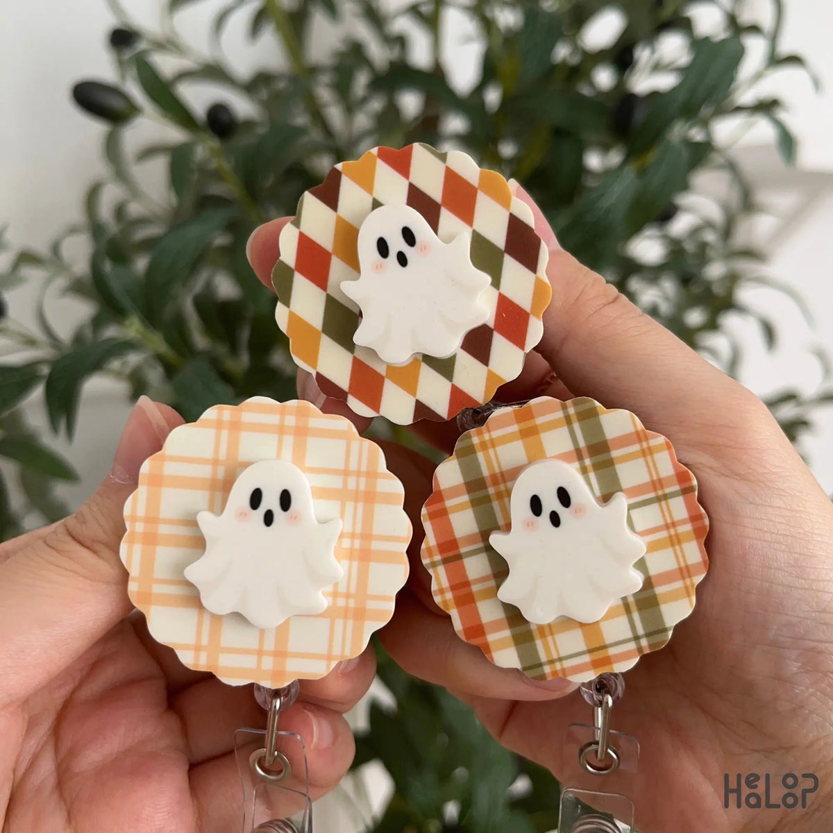 Three 2-layer Ghost Badge Reels with plaid and argyle fall patterns