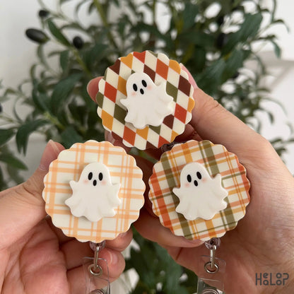 Three 2-layer Ghost Badge Reels with plaid and argyle fall patterns