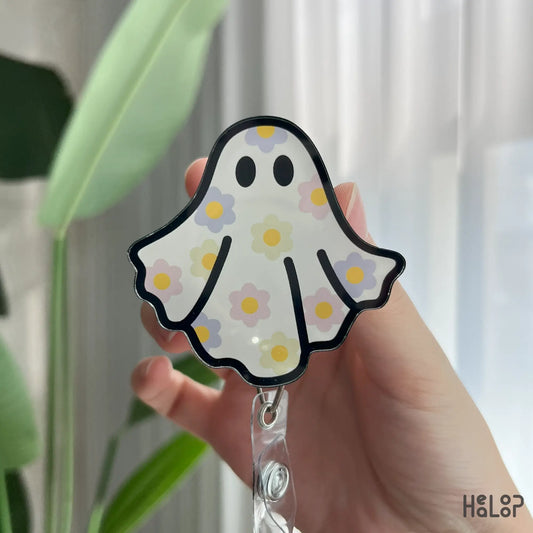 Detailed close-up of floral ghost badge reel, cute retractable Halloween nurse badge clip