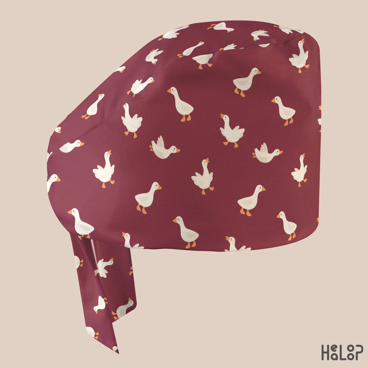 Side profile of HEALOOP Goose Classic Scrub Cap featuring a playful white goose print on burgundy fabric and a comfortable classic surgical hat design.