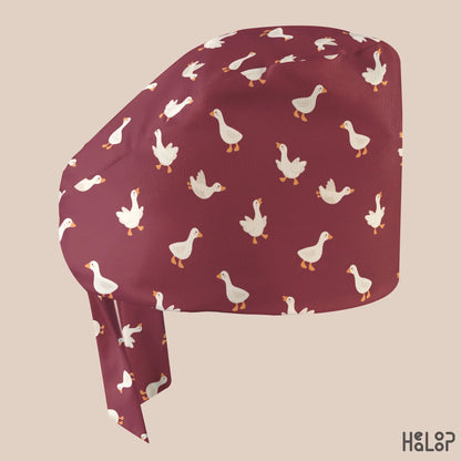 Side profile of HEALOOP Goose Classic Scrub Cap featuring a playful white goose print on burgundy fabric and a comfortable classic surgical hat design.