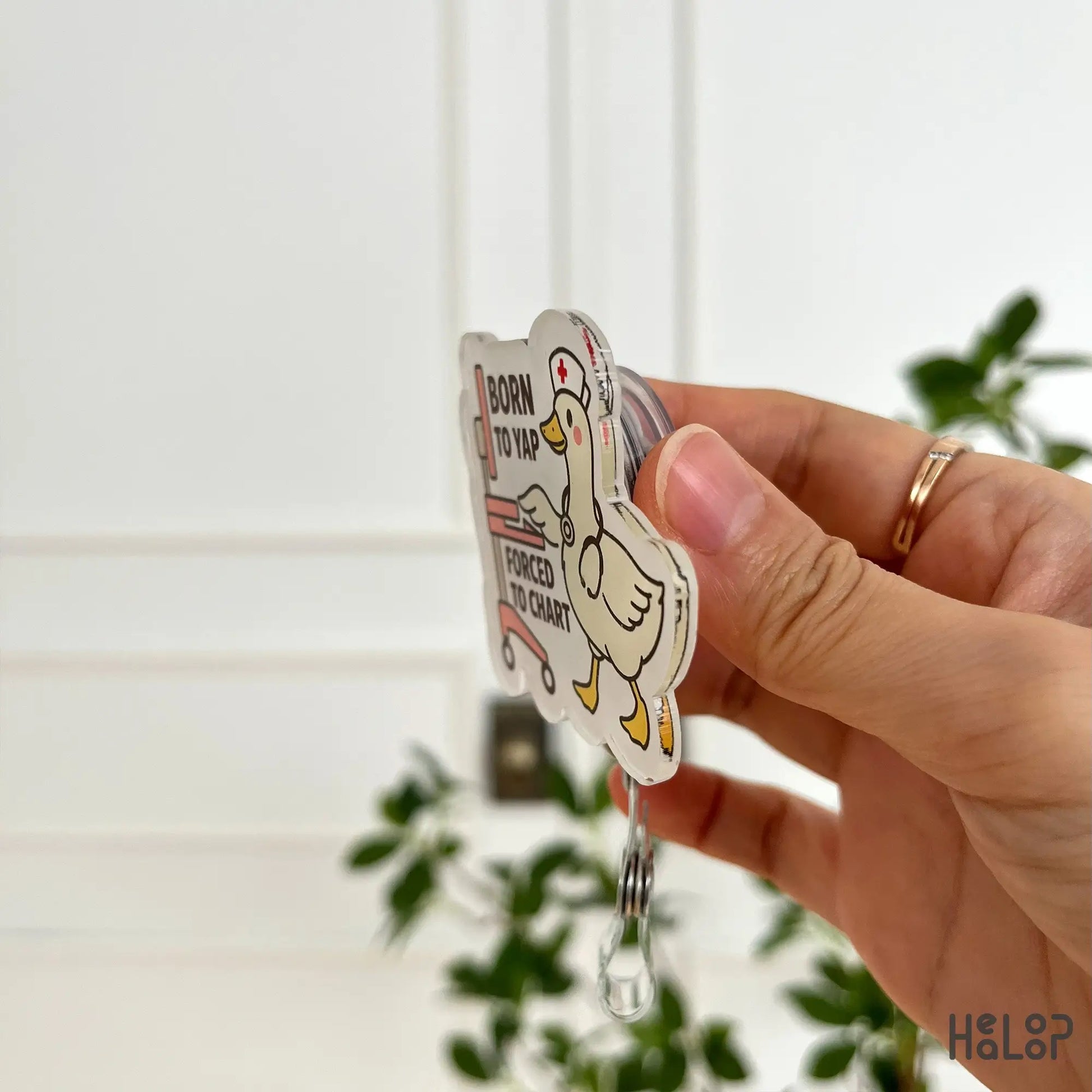 Side angle of “Born to Yap, Forced to Chart” goose nurse badge reel – lightweight and durable design