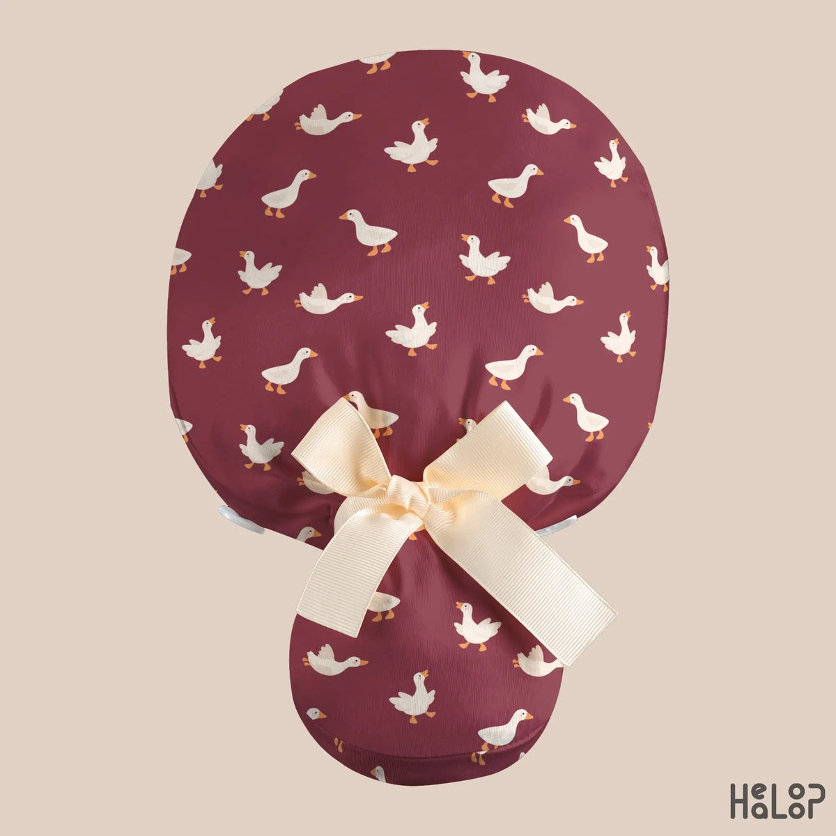 Goose Ponytail Scrub Cap shown from the back, featuring a burgundy goose print, cream ribbon bow, and a spacious pouch designed for long hair.