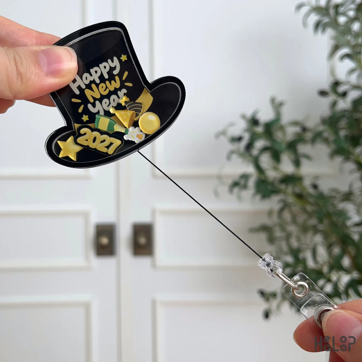 Happy New Year 2027 shaker badge reel with extended retractable cord and clear ID holder clip for convenient badge access.