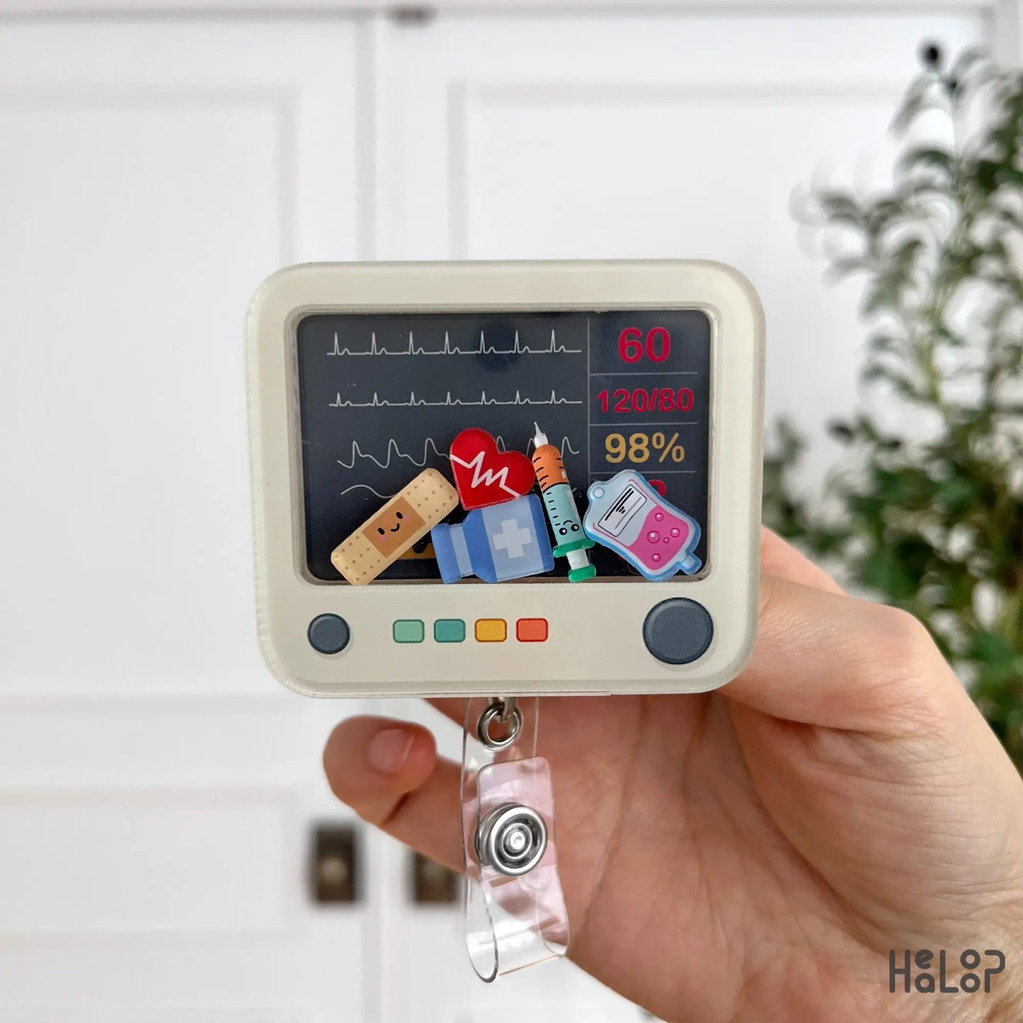 EKG heart monitor shaker badge reel with medical charm decorations and ID clip.