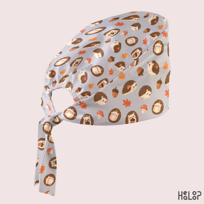 Hedgehog Classic Scrub Cap in an angled side view, showcasing the cute woodland hedgehog pattern, autumn-inspired details, and adjustable tie-back closure.