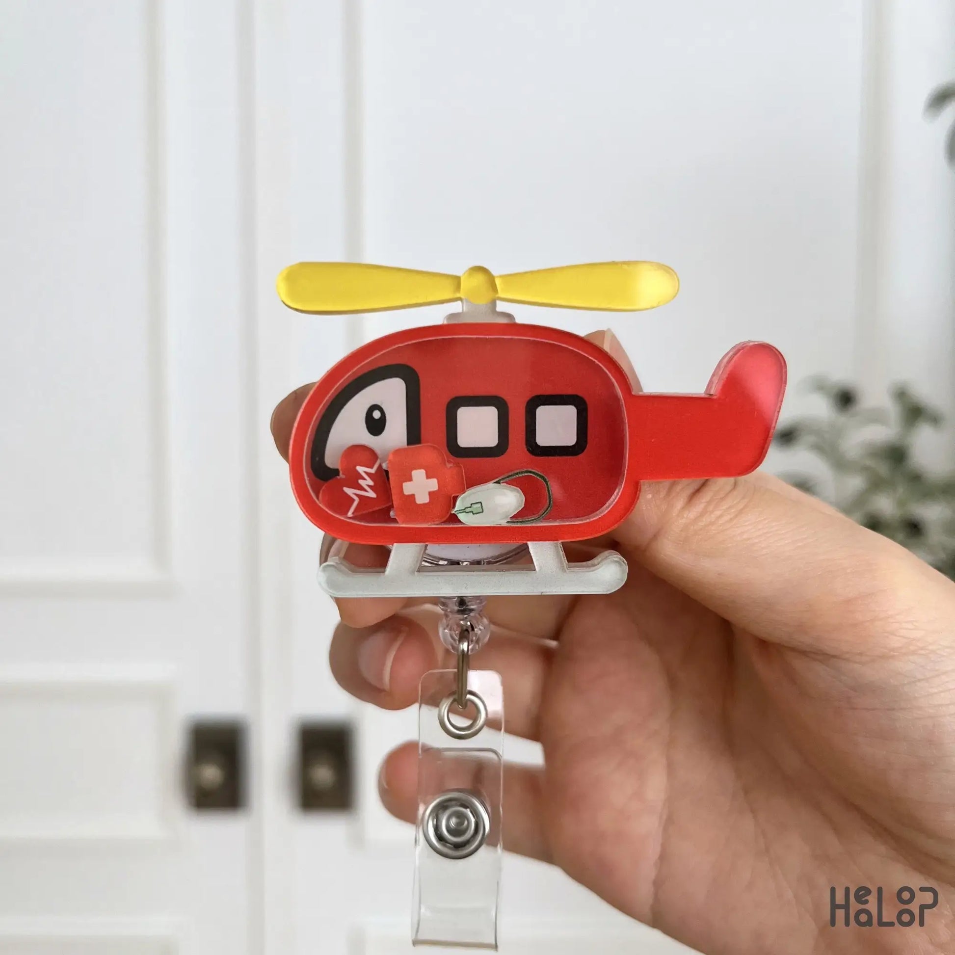 Red rescue helicopter shaker badge reel for flight nurses, EMS professionals, EMTs, and paramedics with cute medical charms.