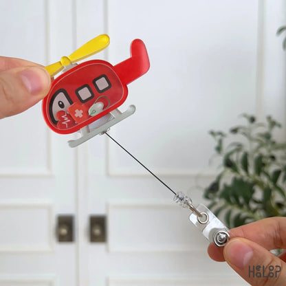 Retractable helicopter badge holder with shaker charms designed for flight nurses, EMTs, paramedics, and emergency medicine staff.