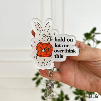 Healoop “Hold On Let Me Overthink This” acrylic badge reel with bunny in orange sweater