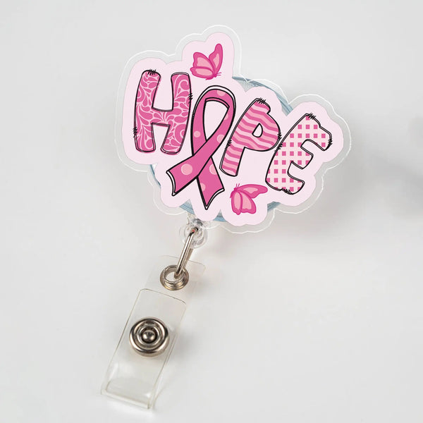 Retractable badge reel featuring the word “HOPE” with a pink ribbon and butterfly design, symbolizing breast cancer awareness.