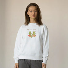 Model wearing a white sweatshirt with 'I think everything will be okay' and a cute frog design.