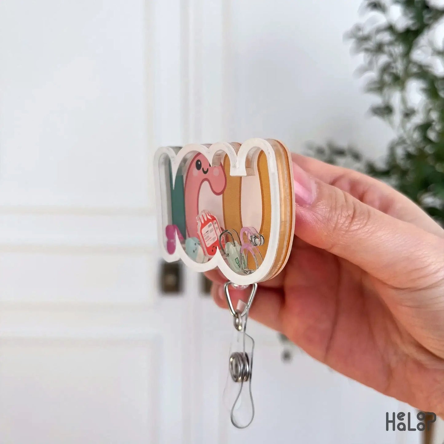 Side profile of ICU shaker badge reel showing layered acrylic badge holder