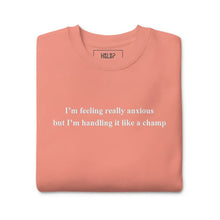 Folded 'I'm feeling really anxious but I'm handling it like a champ' sweatshirt in Dusty Rose, showcasing its cozy fabric and intricate embroidery.