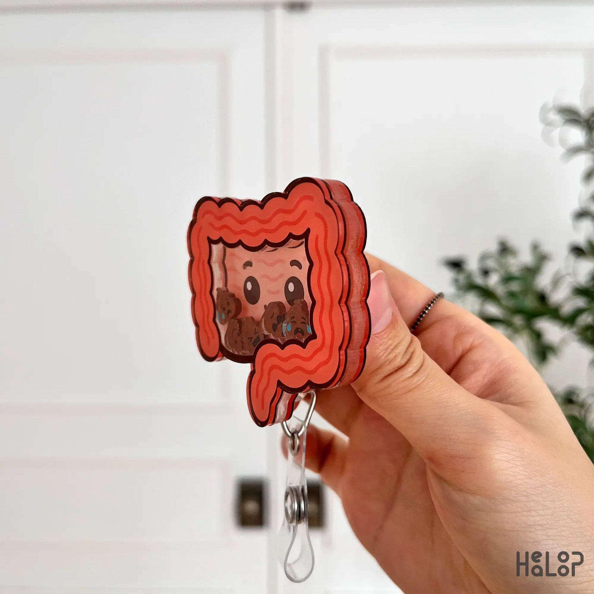 Side profile of acrylic intestine shaker badge reel showing layered thickness for nurses