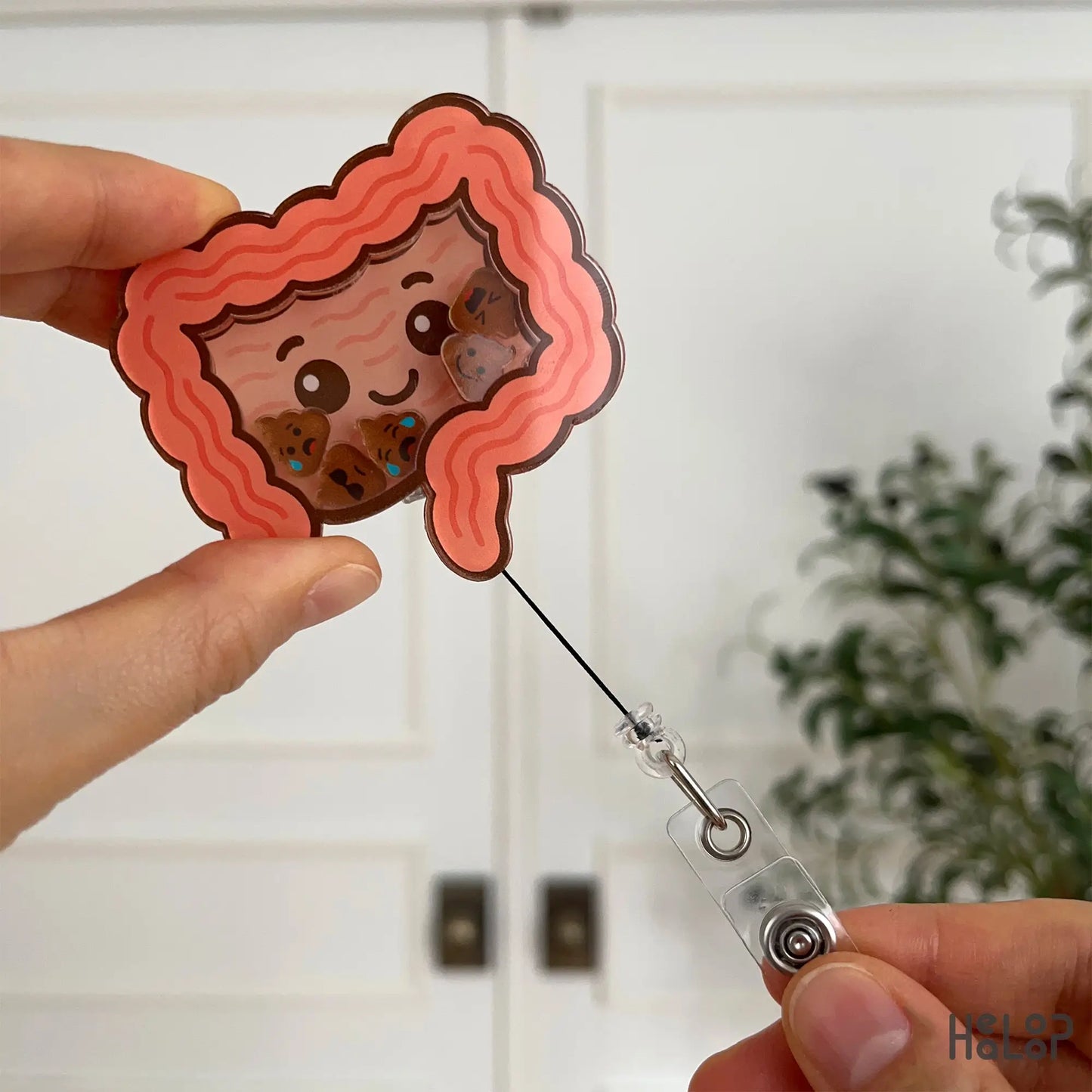 Retractable intestine shaped badge reel for healthcare workers shown with pull cord extended