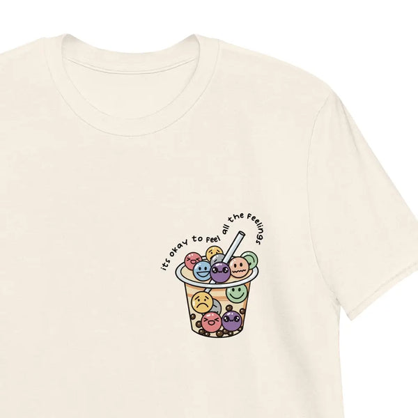 Natural T-shirt with 'It's okay to feel all the feelings' printed alongside a Boba Tea design with tapioca pearls expressing various emotions. Zoom