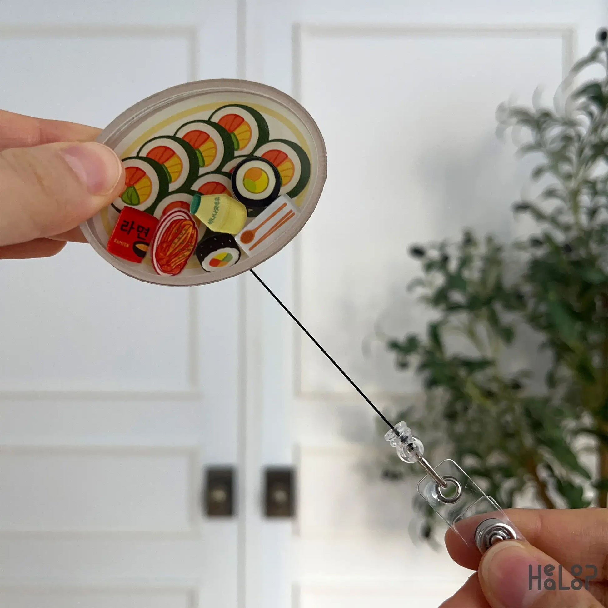 Korean kimbap shaker badge reel displayed with fully extended retractable cord.